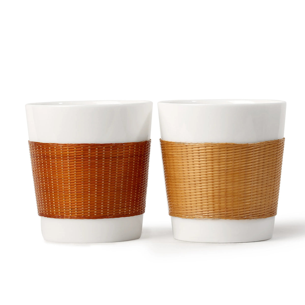 THE YUNXI Daily Cup in Baked and Natural, featuring woven bamboo sleeves over white porcelain.