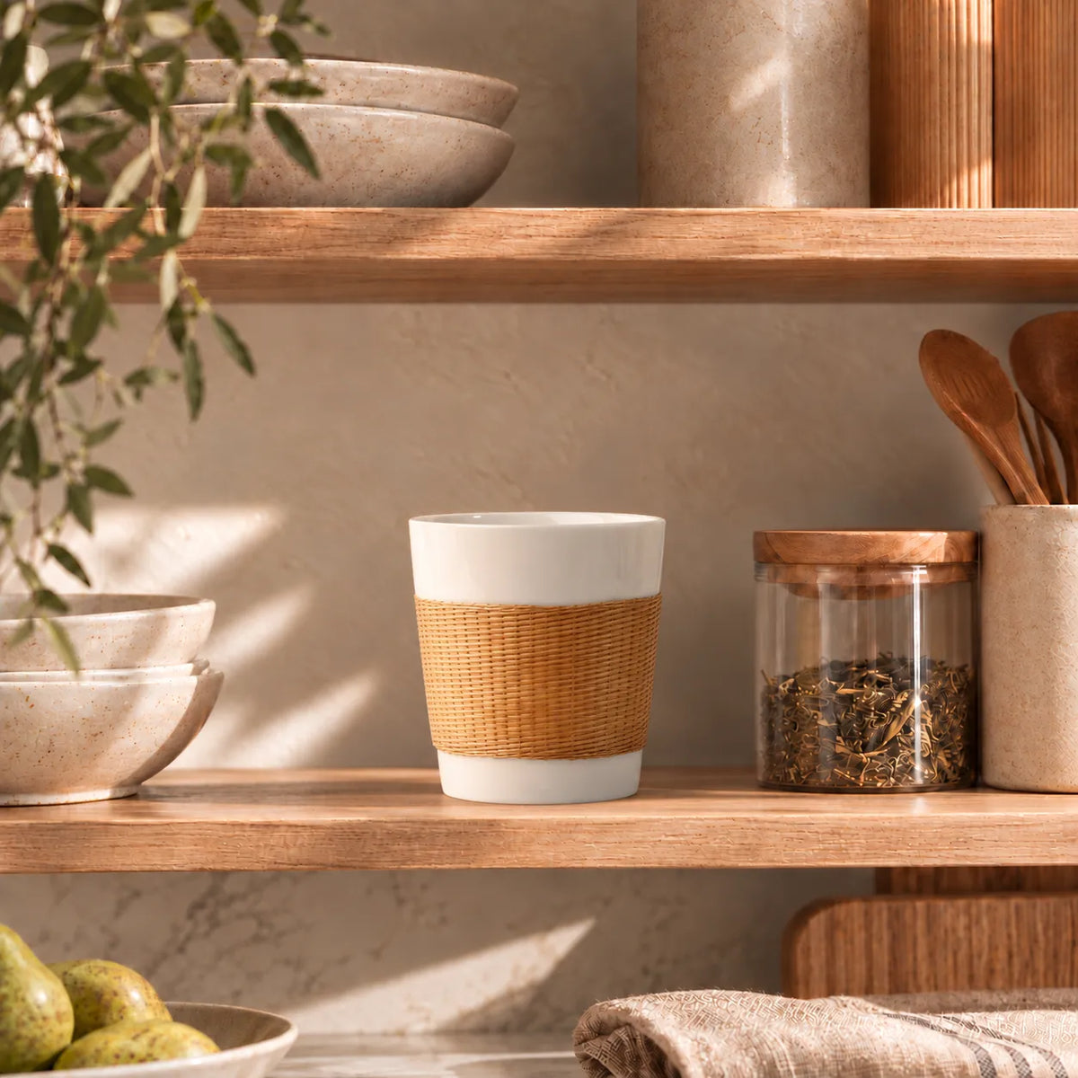 Natural Bamboo over Porcelain Daily Cup on a wooden kitchen shelf beside ceramic bowls and a glass tea jar.