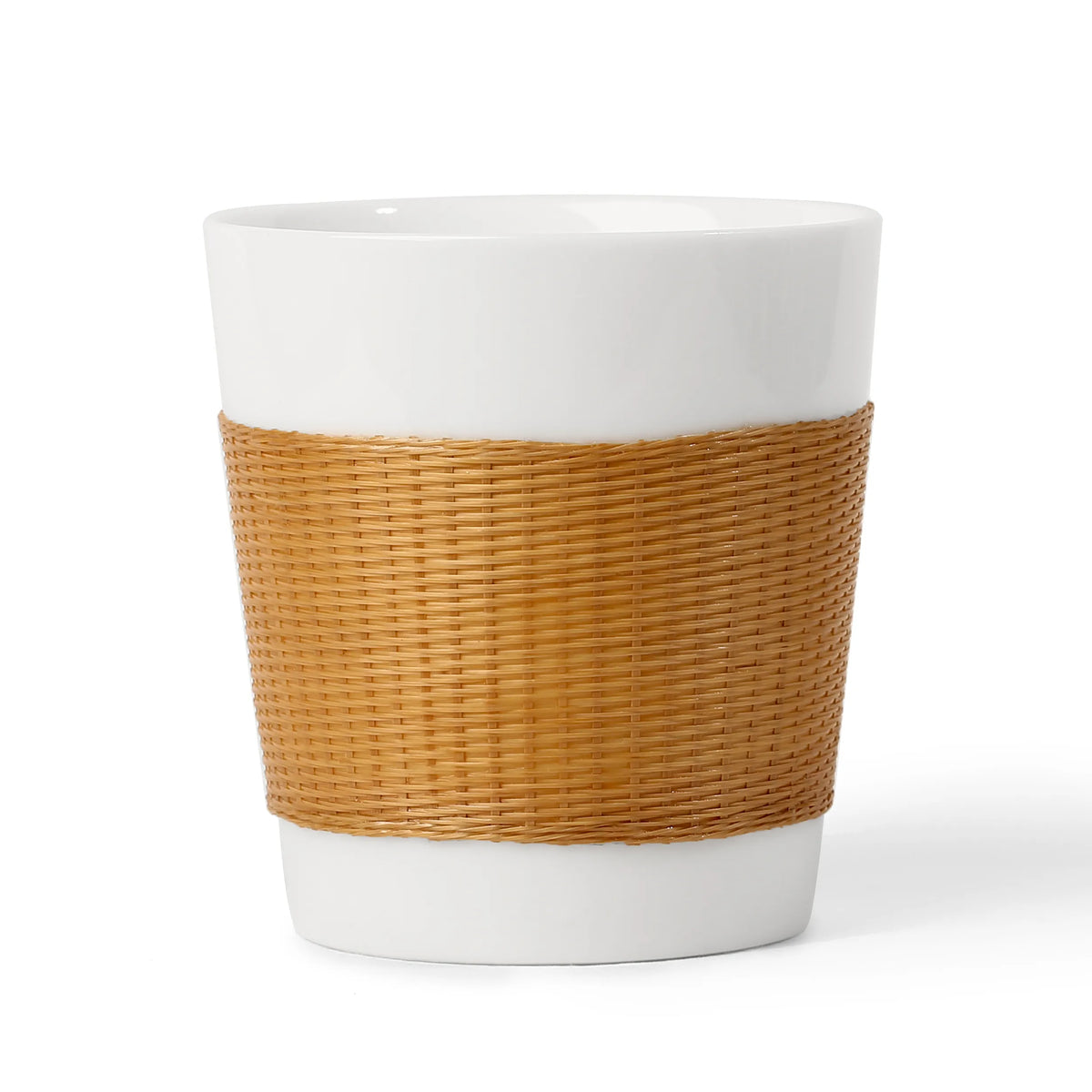 THE YUNXI Daily Cup in Natural, with a light woven bamboo sleeve over white porcelain.