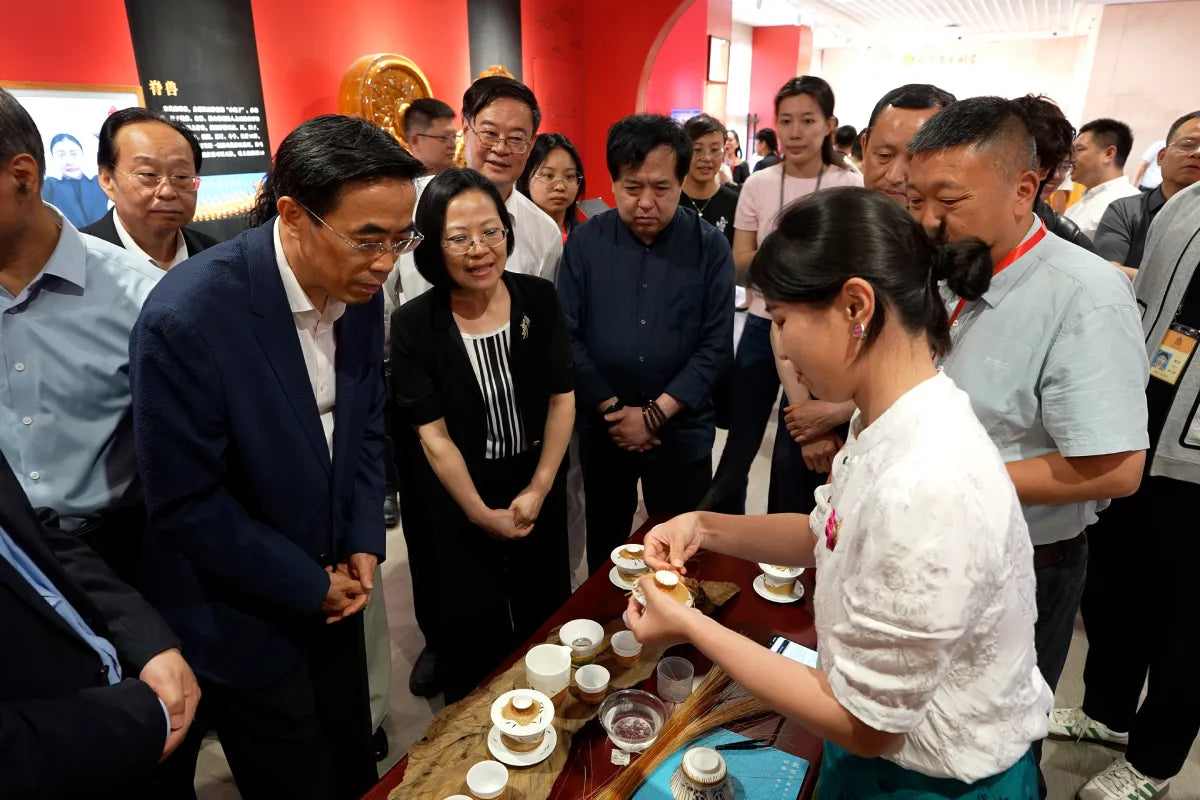 Liu Luolin demonstrating bamboo weaving around porcelain to visitors at the Palace Museum in Beijing.