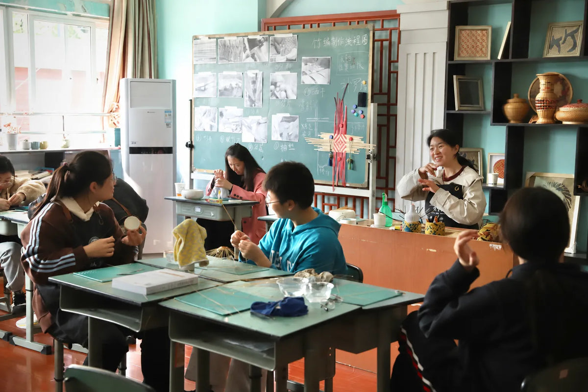 Liu Luolin teaching a student to weave bamboo around a porcelain cup at Chengdu Special Education School.