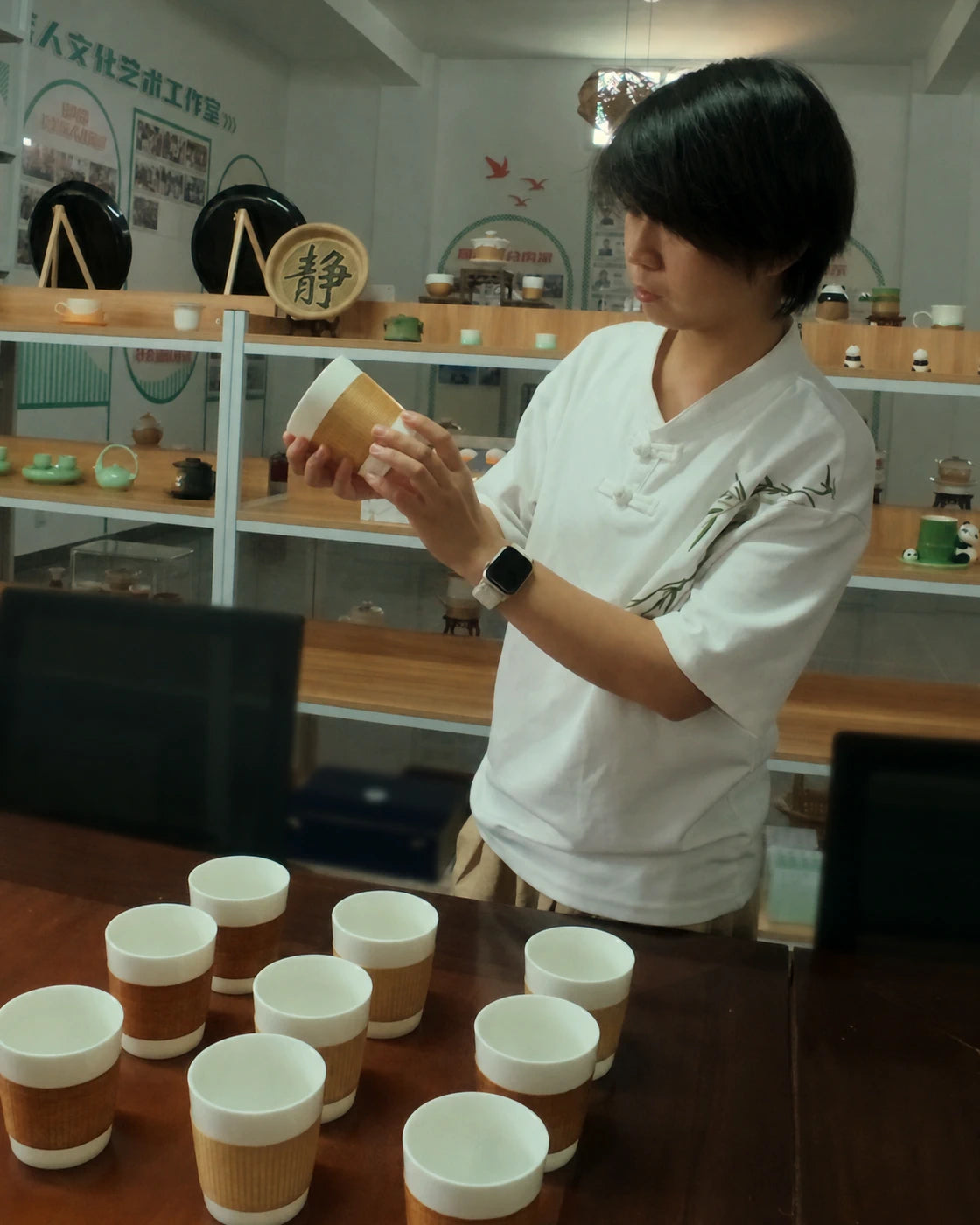 Liu Luolin inspecting the bamboo weave on a finished Daily Cup
